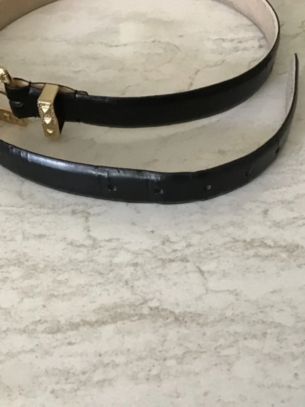 Black leather belt with gold textured buckle